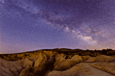 the milky way is visible in the night sky above a desert landscape