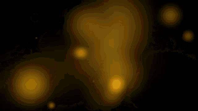 a bunch of red and yellow circles are floating in the air