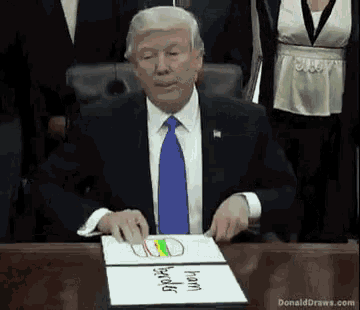 a man in a suit and tie is sitting at a table with a drawing of a hamburger on it .