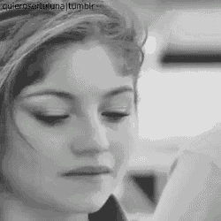 a black and white photo of a woman 's face with a sad look on her face .