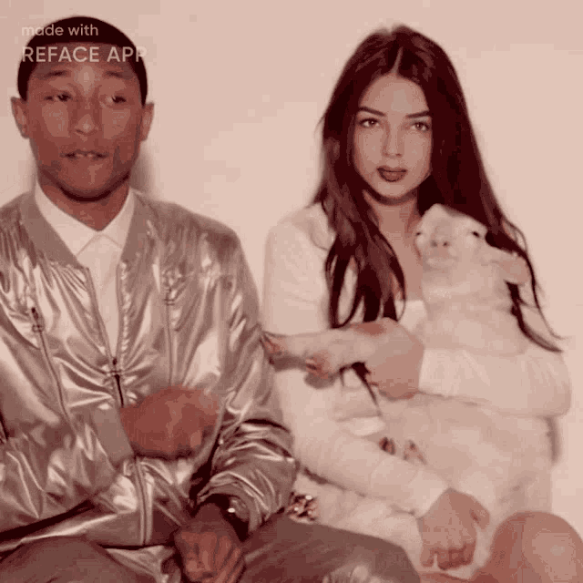a man and a woman are sitting next to each other with a sheep in their lap