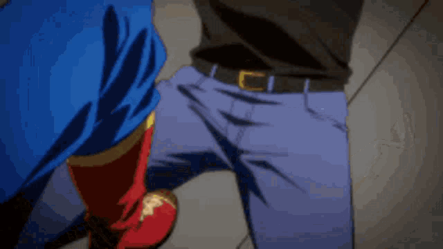 a blurry picture of a man in a black tank top and blue pants kicking another man 's leg .