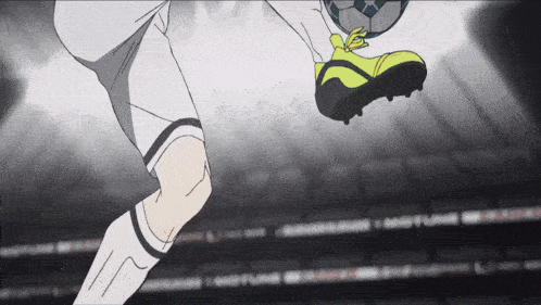 a soccer player kicking a ball with a yellow shoe on