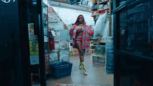 a woman stands in a store with a sign that says ' cotton ' on it