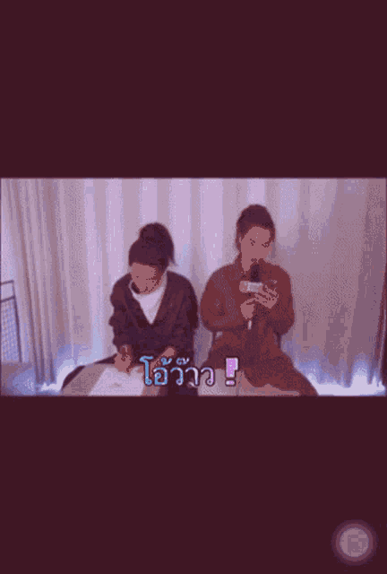 two people are sitting at a table and one of them is writing