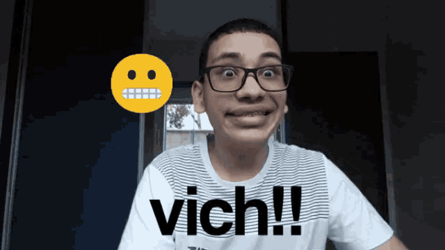 a young man wearing glasses and a shirt that says " vich "