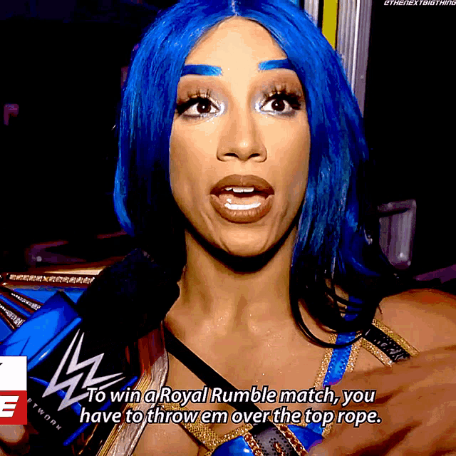 a woman with blue hair is talking into a microphone and says to win a royal rumble match you have to throw em over