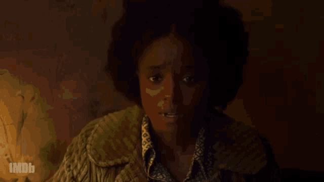 a close up of a woman 's face with imdb written on the bottom right