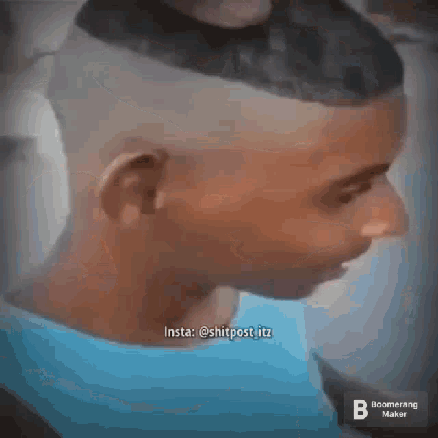 a man with a shaved head is smiling .