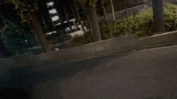 a blurry picture of a person walking down the street at night