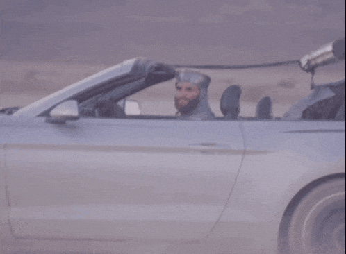 a man in a knight 's helmet is sitting in a car