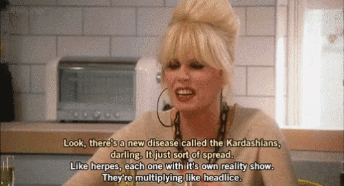 a woman is sitting at a table and talking about a new disease called the kardashians