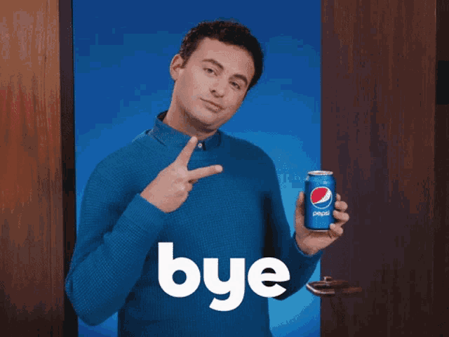 a man in a blue sweater is holding a can of pepsi and says bye