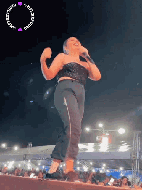 a woman singing into a microphone with a circle around her that says ' refugio ' on it