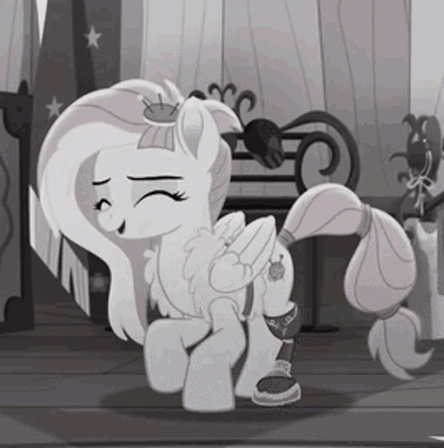a white pony with a crown on her head is standing on a wooden floor