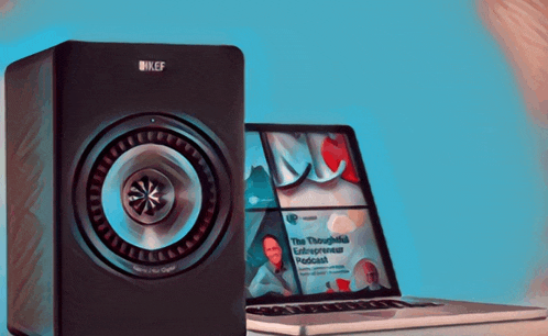 a kef speaker sits next to a laptop that says the thoroughly entrepreneur podcast