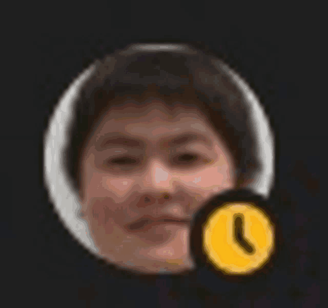 a close up of a man 's face with a yellow clock icon next to it .