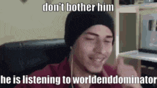 a man wearing a beanie and headphones is listening to a podcast .