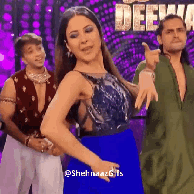 a woman in a blue dress is dancing in front of a sign that says deejay