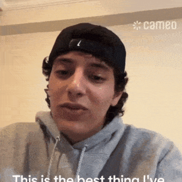 a man wearing a baseball cap and a hoodie says this is the best thing i 've ever done