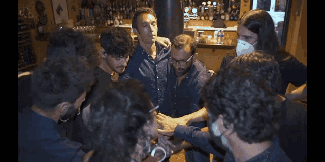 a group of people are standing in a circle with a star in the middle