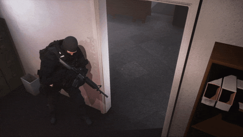 a man in a black mask holds a gun in a room