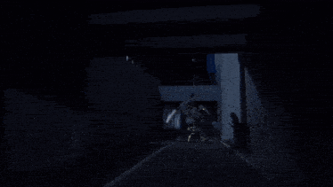 a dark tunnel with a sign on the wall that says ' a ' on it