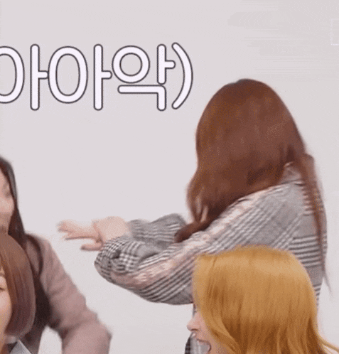 a group of women are standing in front of a white wall with the letters oioio written on it