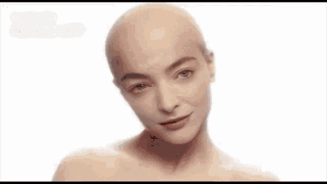 a woman without a shirt is making a funny face with her tongue out .