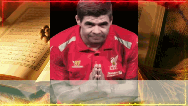a man wearing a red shirt that says liverpool is praying