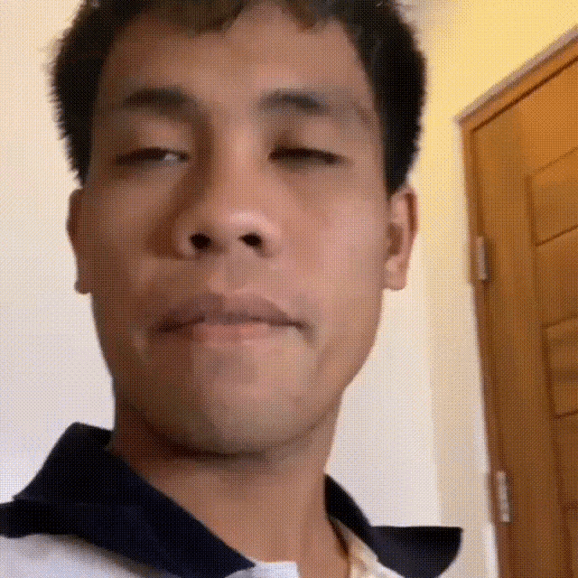 a close up of a man 's face with his eyes closed .