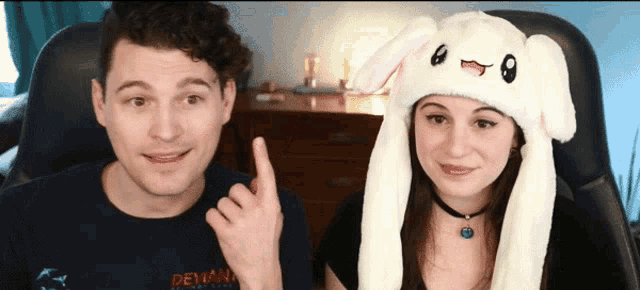 a man and a woman wearing bunny hats and a shirt that says devana