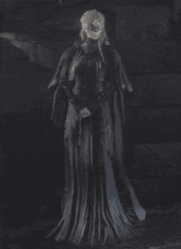 a statue of a woman in a long black dress