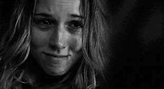 a black and white photo of a woman crying with tears coming out of her eyes .