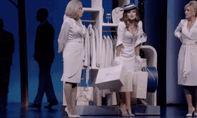 a woman in a white dress is holding a bag that says ' chanel ' on it