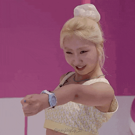 a woman with blonde hair is wearing a watch and smiling