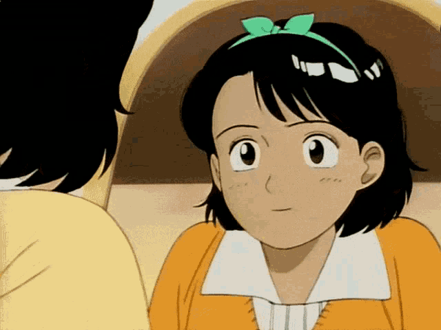 a girl with a green bow on her head