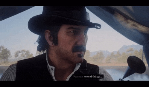 a man in a cowboy hat and vest is talking to pearson