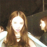 a woman with long brown hair is sitting in a chair