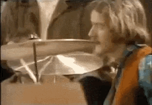 a close up of a person playing a drum set in a room .