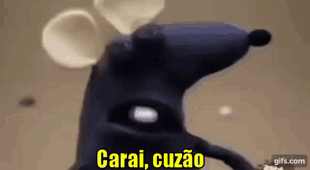 a close up of a cartoon mouse with the words carai cuzao written on it .