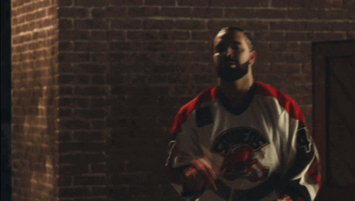a man wearing a spider-man jersey with the number 4 on it