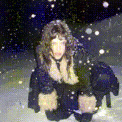 a woman is standing in the snow wearing a fur coat