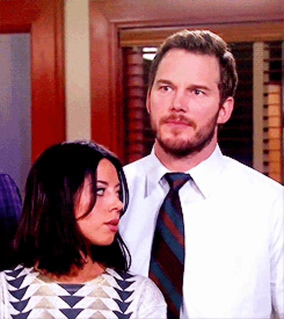 a man and woman are standing next to each other