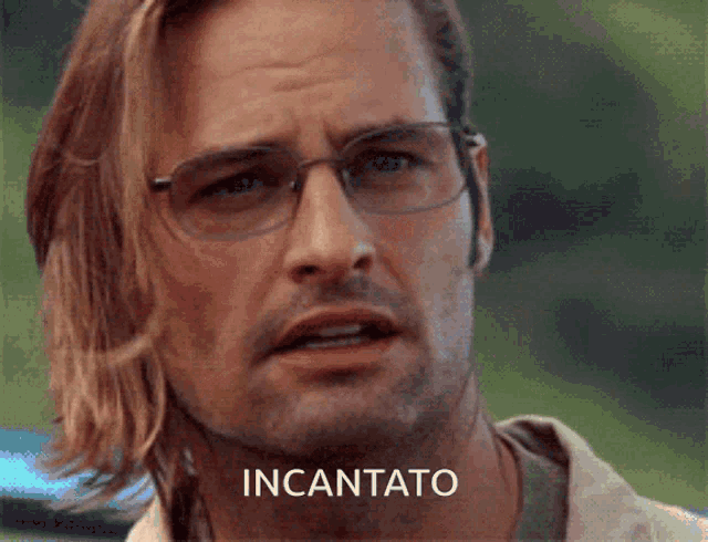 a man wearing glasses has the word incanto on his forehead