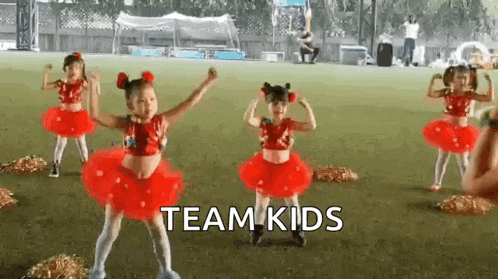 a group of young girls are dancing together on a field .