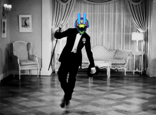 a man in a tuxedo is dancing in a room with a couch and chairs