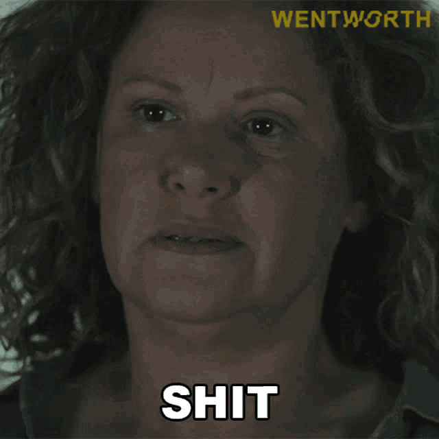 a close up of a woman 's face with the word shit written on it