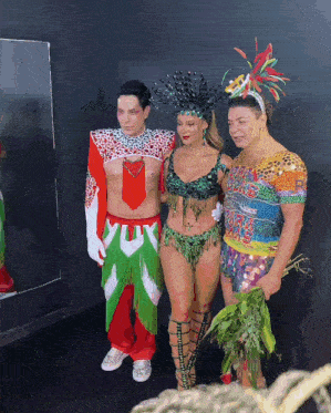 a group of people posing for a picture including a man in a leopard print shirt