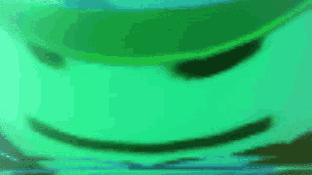 a close up of a green balloon with a face on it .